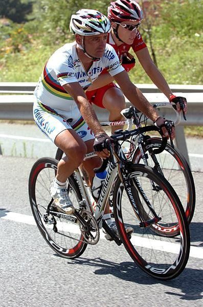 Paolo Bettini (Quick Step) rides along.