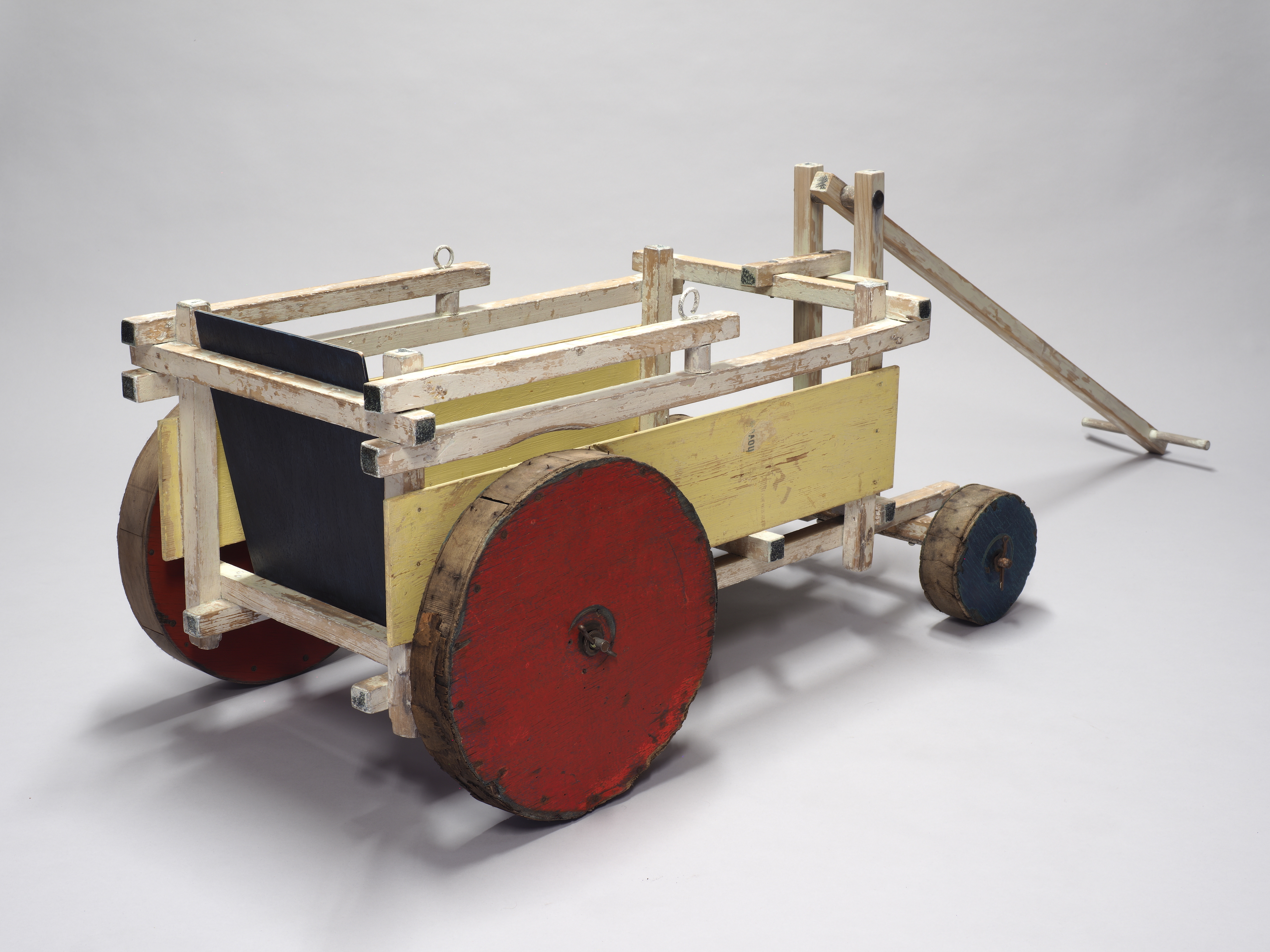 A beach buggy by Gerrit Rietveld made of wood and painted red, yellow and blue, seen at TEFAF Maastricht 2026