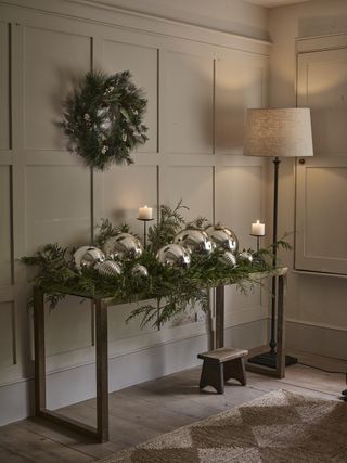 Oversized bauble decorations on an entryway table The White Company