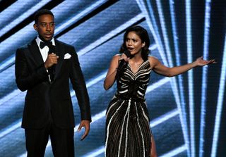 Ludacris and Vanessa Hudgens perform on stage.