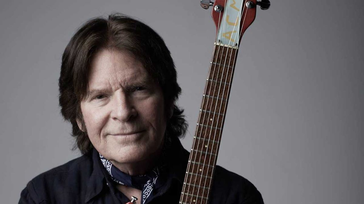 John Fogerty cradling a guitar