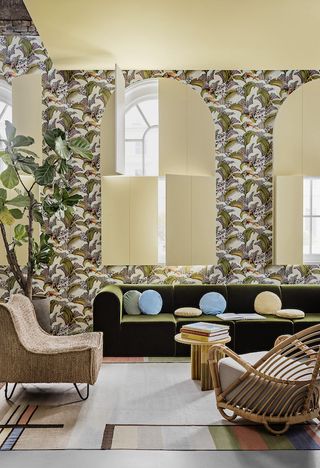 A living room with botanical wallpaper