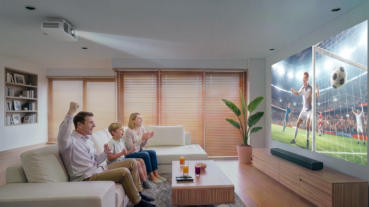 A family watching a football game beamed from a projector overhead