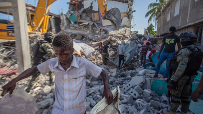 Survivors search earthquake rubble