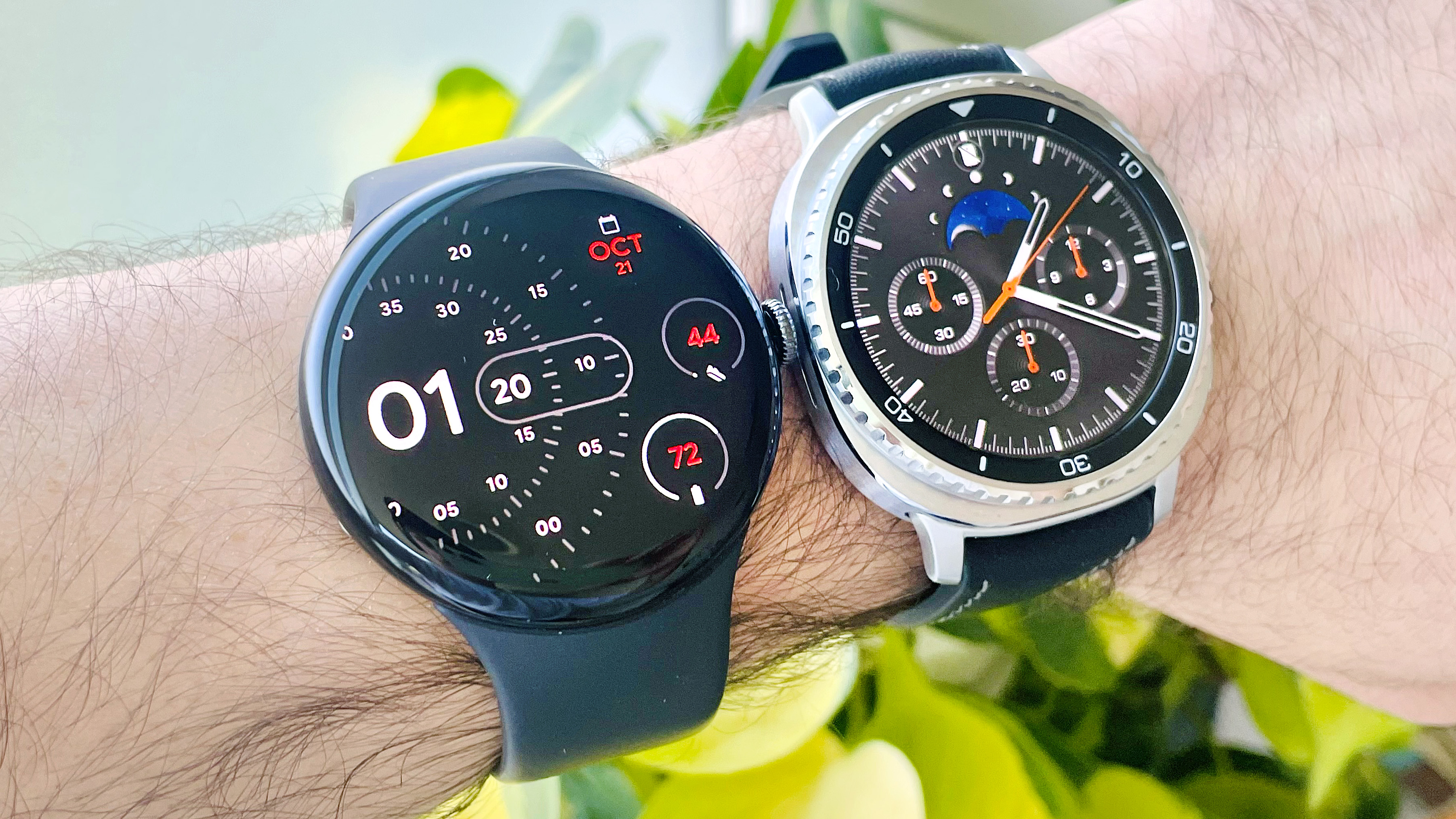 Close-up of the Google Pixel Watch 4 on a user's wrist next to the Samsung Galaxy Watch 8 Classic