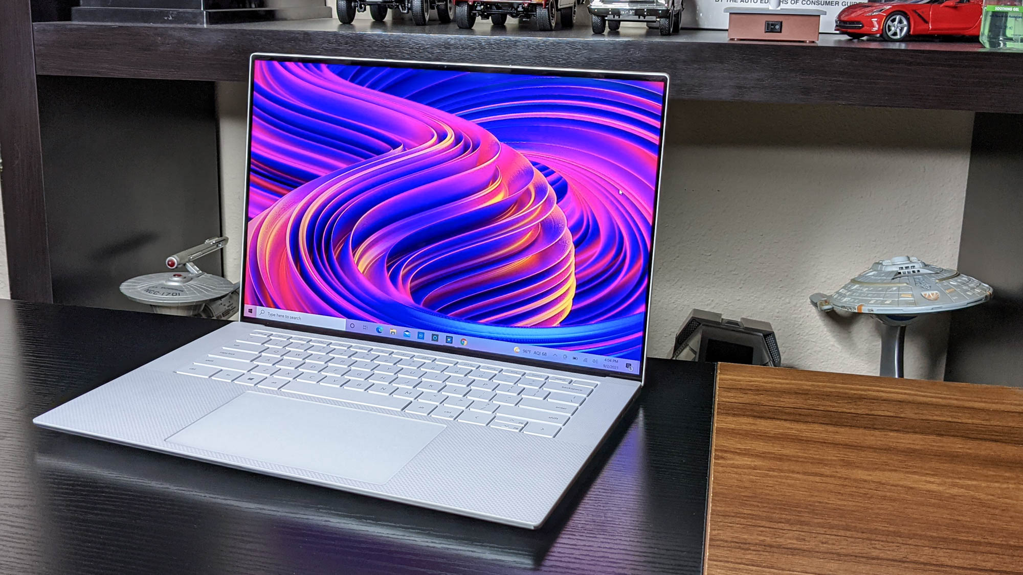 Dell XPS 15 OLED (2021) on a desk with Star Trek models behind it