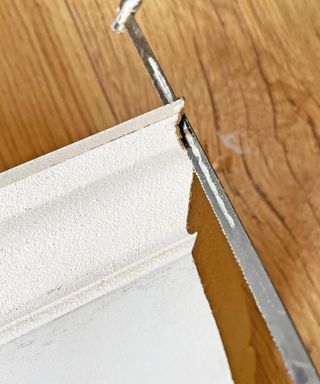 a hack saw scribing a piece of skirting board