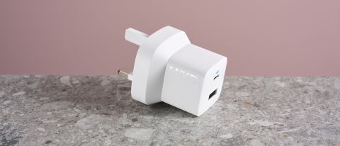 Anker 323 Charger (33W) sat on stone surface with prongs folded outwards