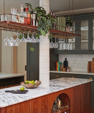 hanging home bar storage unit in middle of kitchen