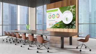 The new all-in-one LG dvLED display in an empty conference room showing multiple charts and graphs.