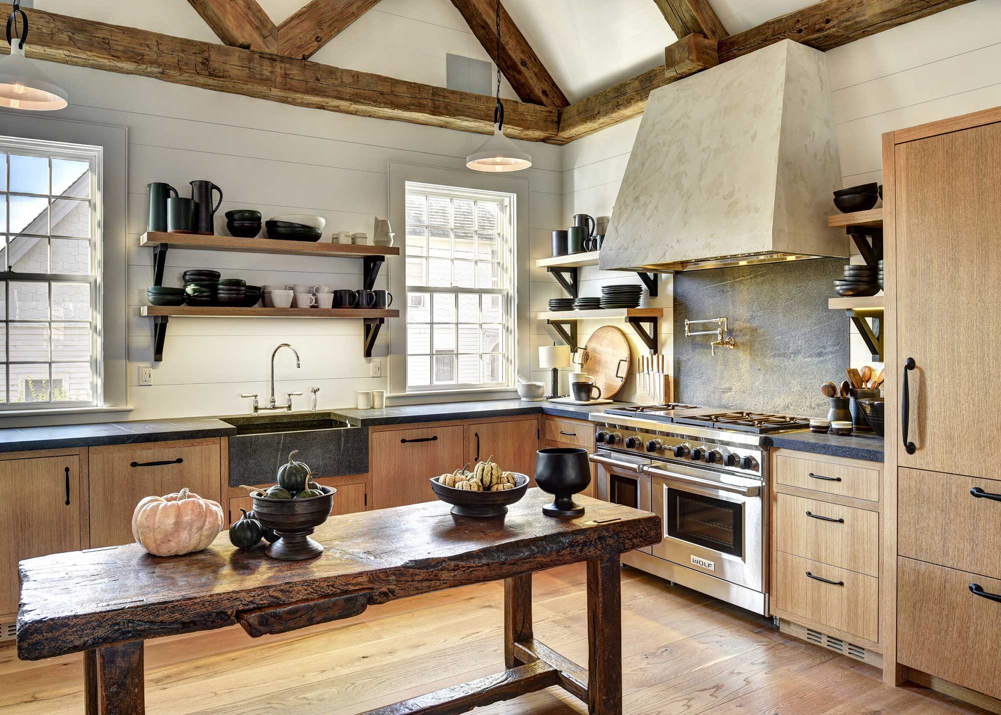 luxury farmhouse kitchen with wooden cabinets and rustic kitchen table
