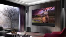 The LG G3 OLED TV hanging in a living room displaying a dramatic scene of a stag on moorland.