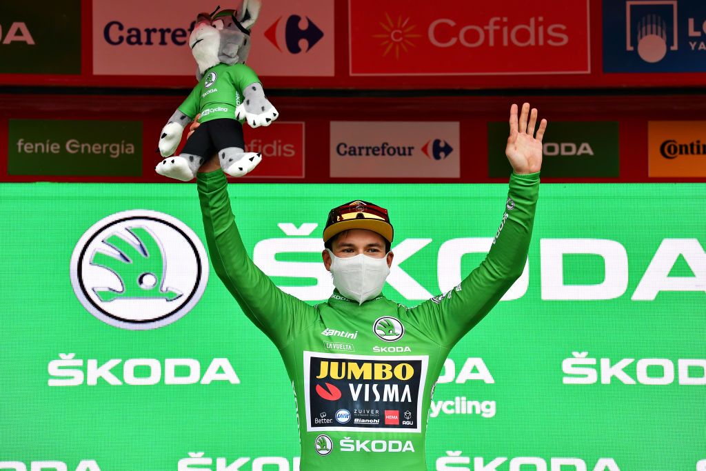 LEKUNBERRI SPAIN OCTOBER 21 Podium Primoz Roglic of Slovenia and Team Jumbo Visma Green Points Jersey Celebration Mascot Mask Covid safety measures during the 75th Tour of Spain 2020 Stage 2 a 1516km stage from Pamplona to Lekunberri lavuelta LaVuelta20 La Vuelta on October 21 2020 in Lekunberri Spain Photo by Justin SetterfieldGetty Images