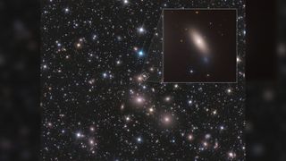 Zoomed-out Hubble view of NGC 1277, which lies near the center of the Perseus cluster of over 1,000 galaxies, located 240 million light-years away from Earth. thousands of stars and galaxies can be seen against the black of space.