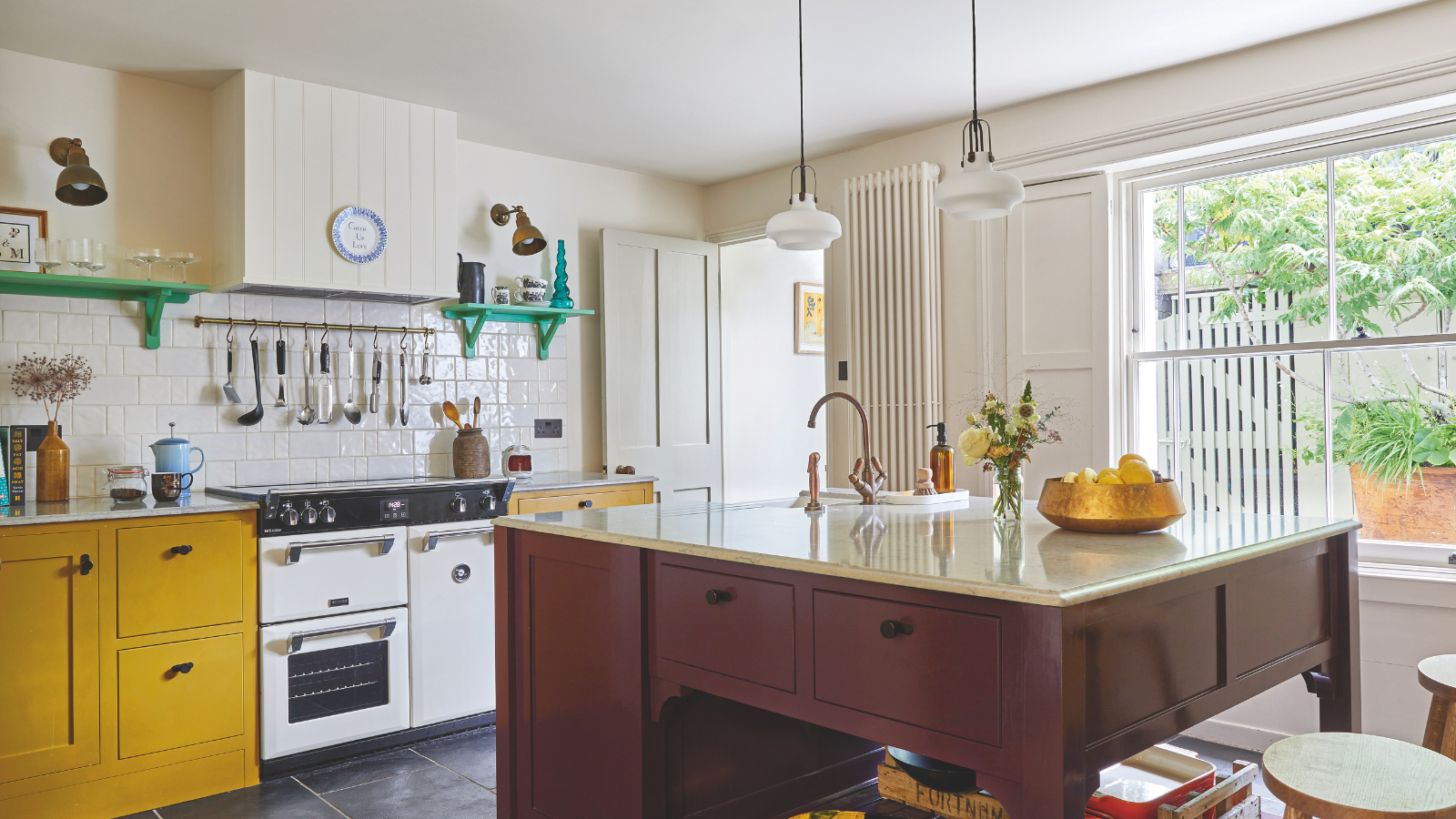 a kitchen with yellow cabinets, a white oven, and a brown wooden freestanding island