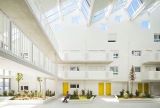Inside, the two building flank an high ceilinged courtyard that contains an internal garden