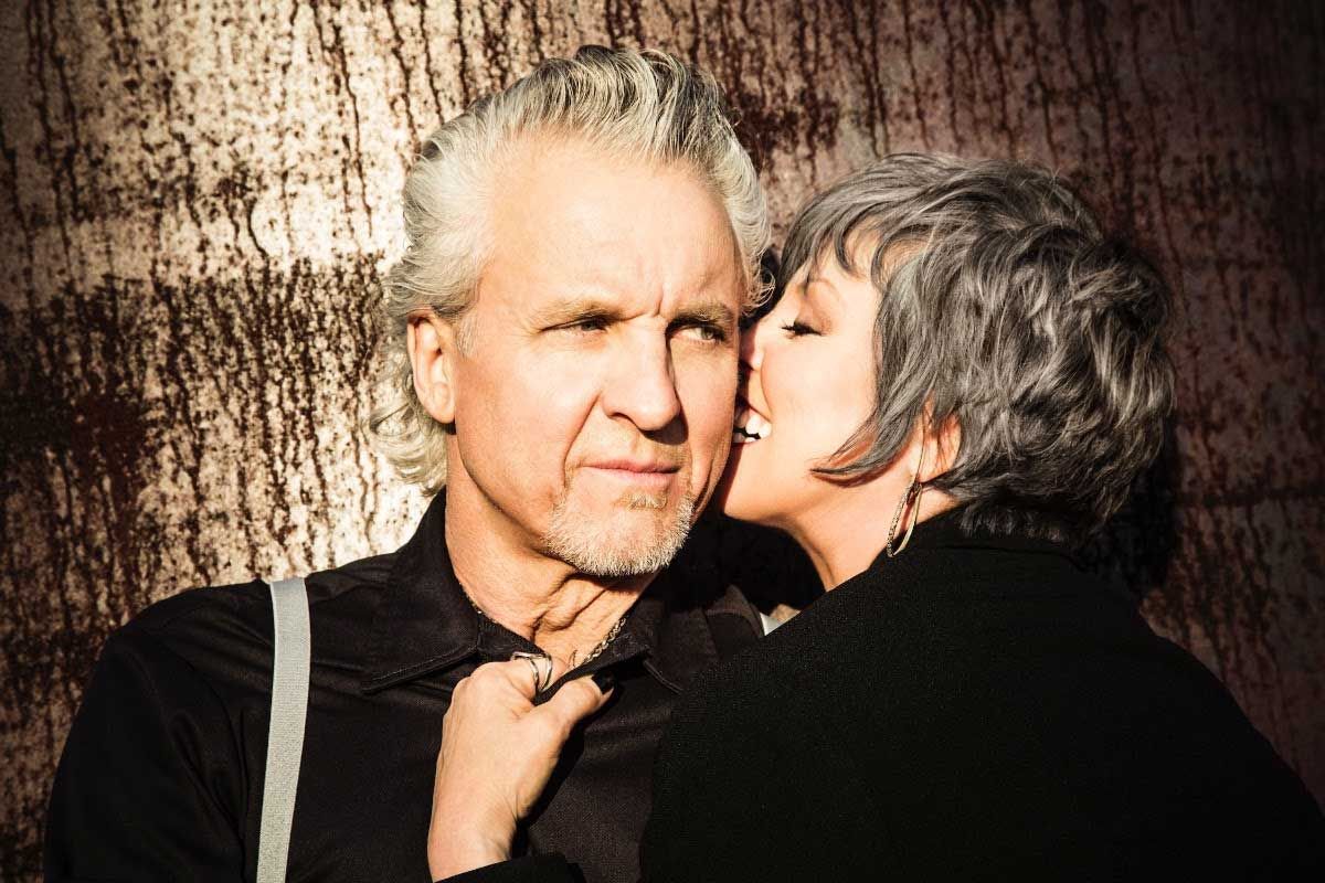 Neil Giraldo looking moody as Psat Benatar snuggles up against him