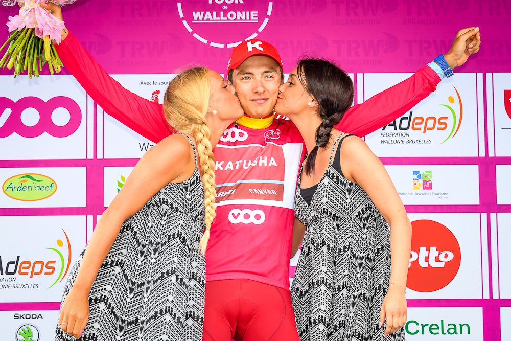 Viacheslav Kuznetsov celebrates on the podium with the best sprinter's fuchsia jersey, after the first stage of the Tour De Wallonie