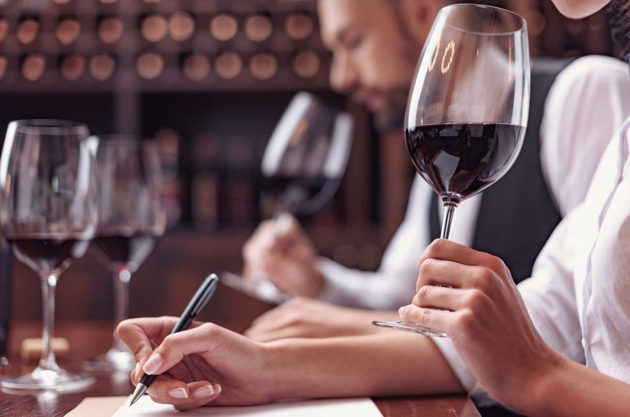 Sommeliers writing wine notes