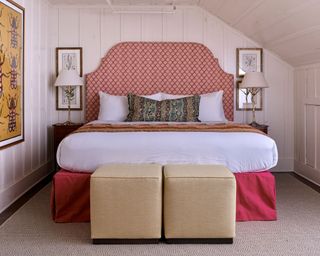pink bedroom with patterned headboard and panelled walls