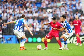 Charalambos Charalambous of Omonia Nicosia is challenged by Ander Guevara of Real Sociedad during the UEFA Europa League group E match between Real Sociedad and Omonia Nikosia at Reale Arena on September 15, 2022 in San Sebastian, Spain.