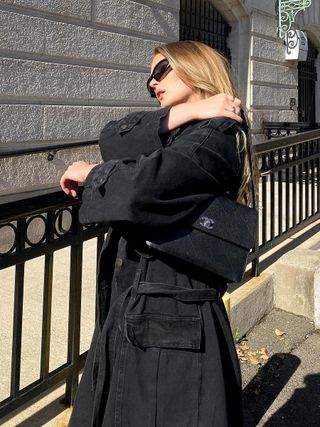 Michelle Rose Drumm wearing a black coat and Chanel handbag.