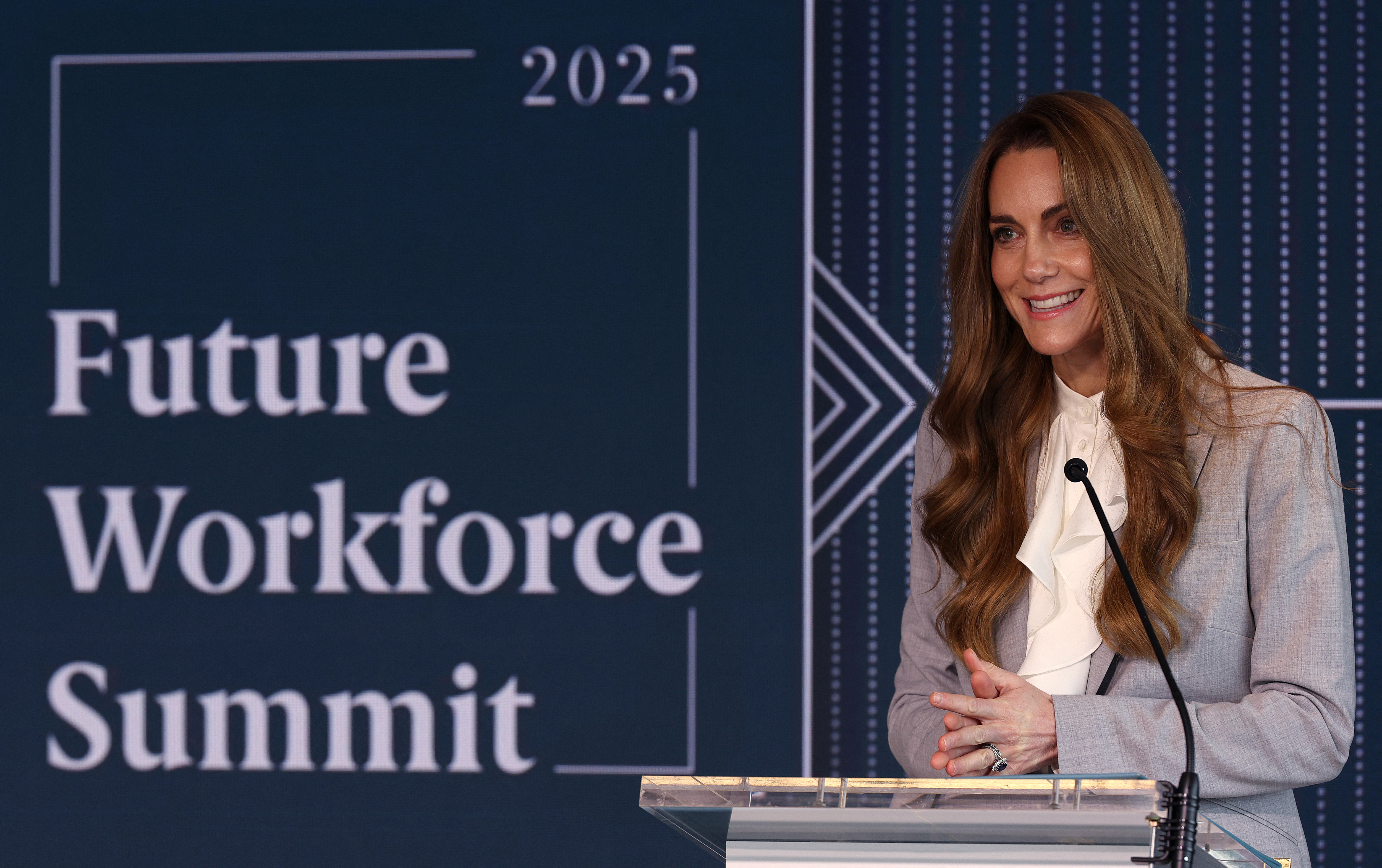 Kate Middleton wearing a pale gray suit giving a speech in front of a sign reading 2025 Future Workforce Summit