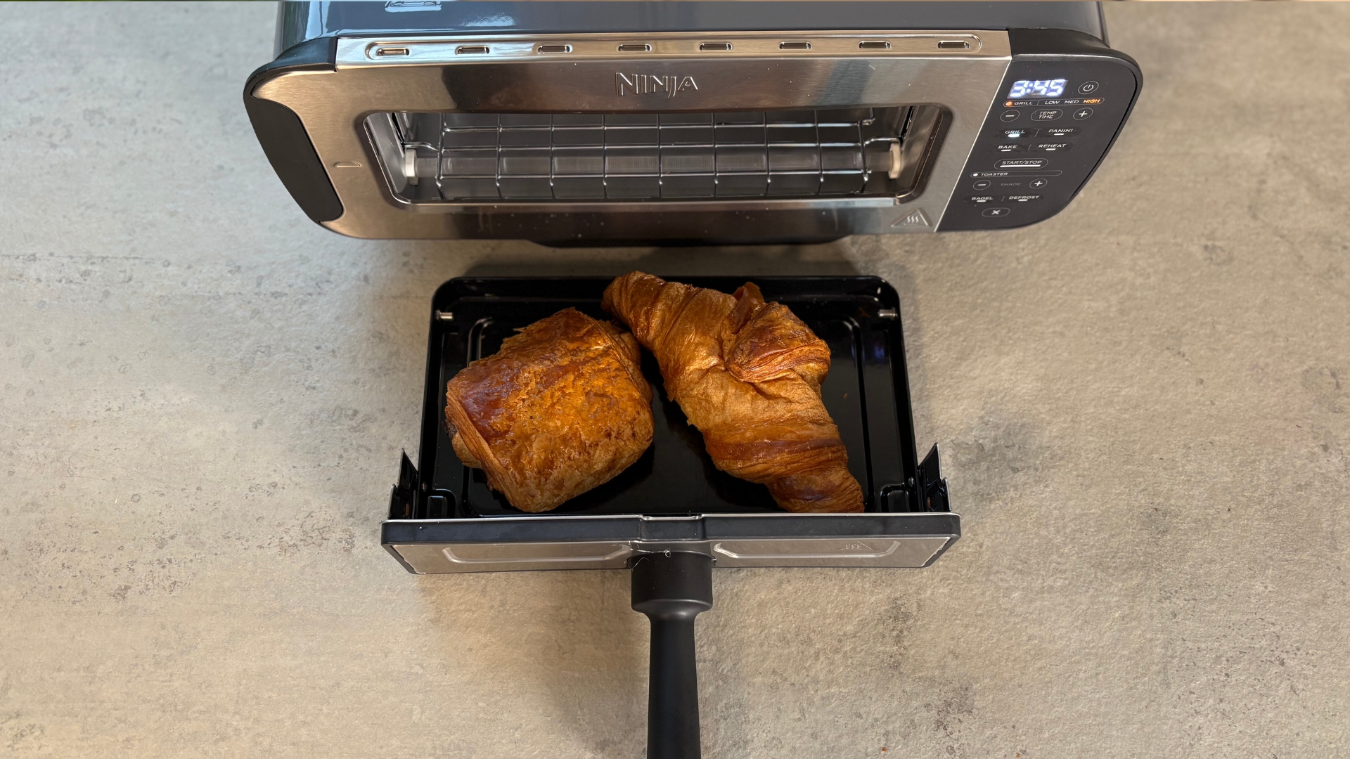 Testing the Ninja Foodi 3-in-1 Toaster Grill Panini Press on the counter baking a croissant and pain au chocolat