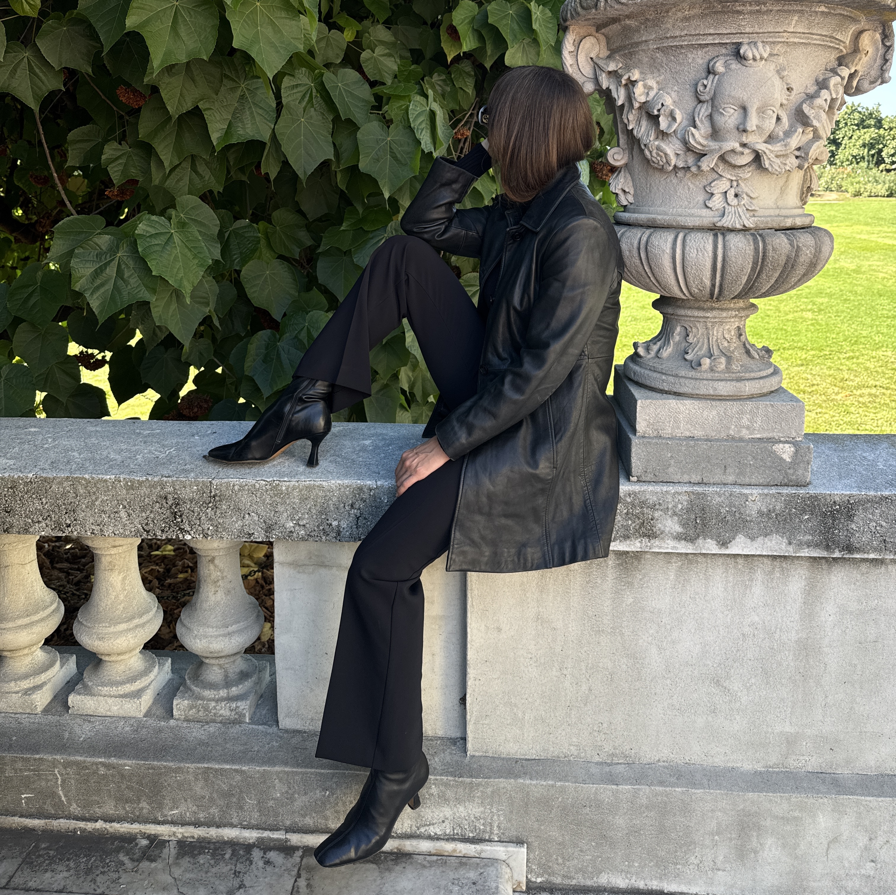 Kathryn Zahorak wearing black leather jacket, sunglasses, black boots