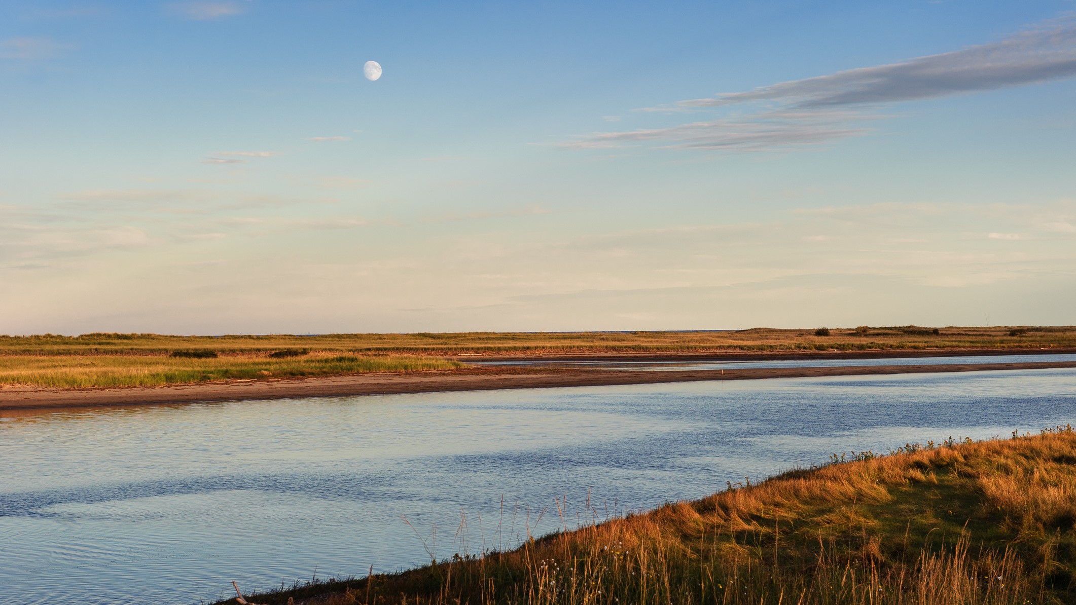 The full moon rises over the Northumberland strait near Kelly's Beach, Kouchibouguac National Park, New Brunswick, Canada