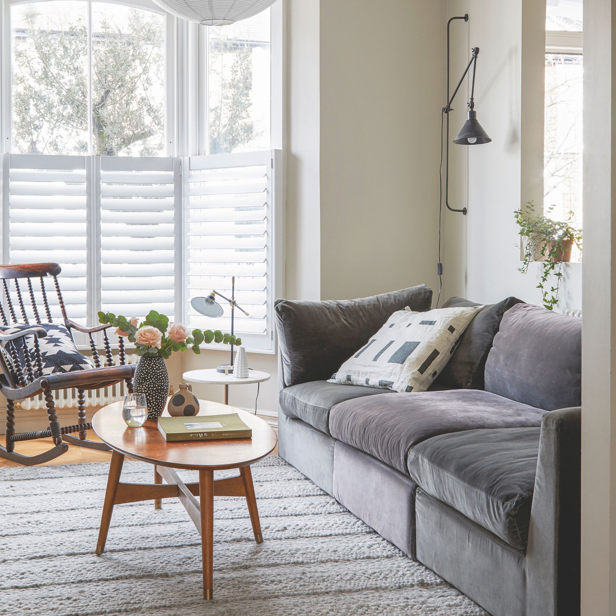 Neutral painted living room with grey sofa and a wooden coffee table in front of it