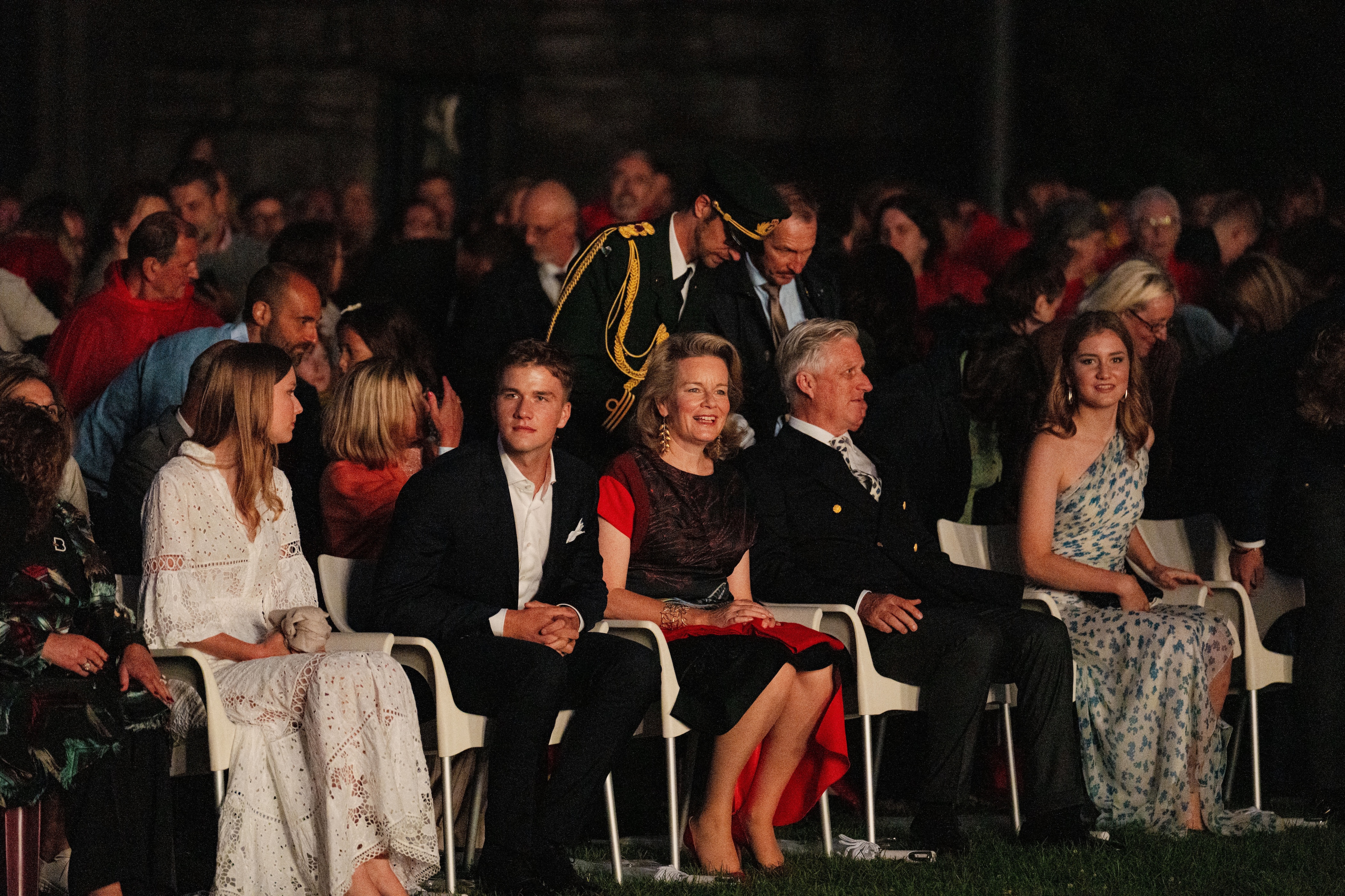 Princess Elisabeth sitting in a chair next to King Philippe, Queen Mathilde, Princess Eleanore