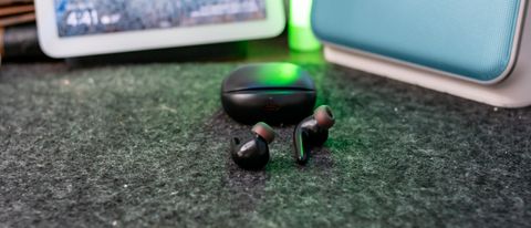1More Aero earbuds with charging case on a table