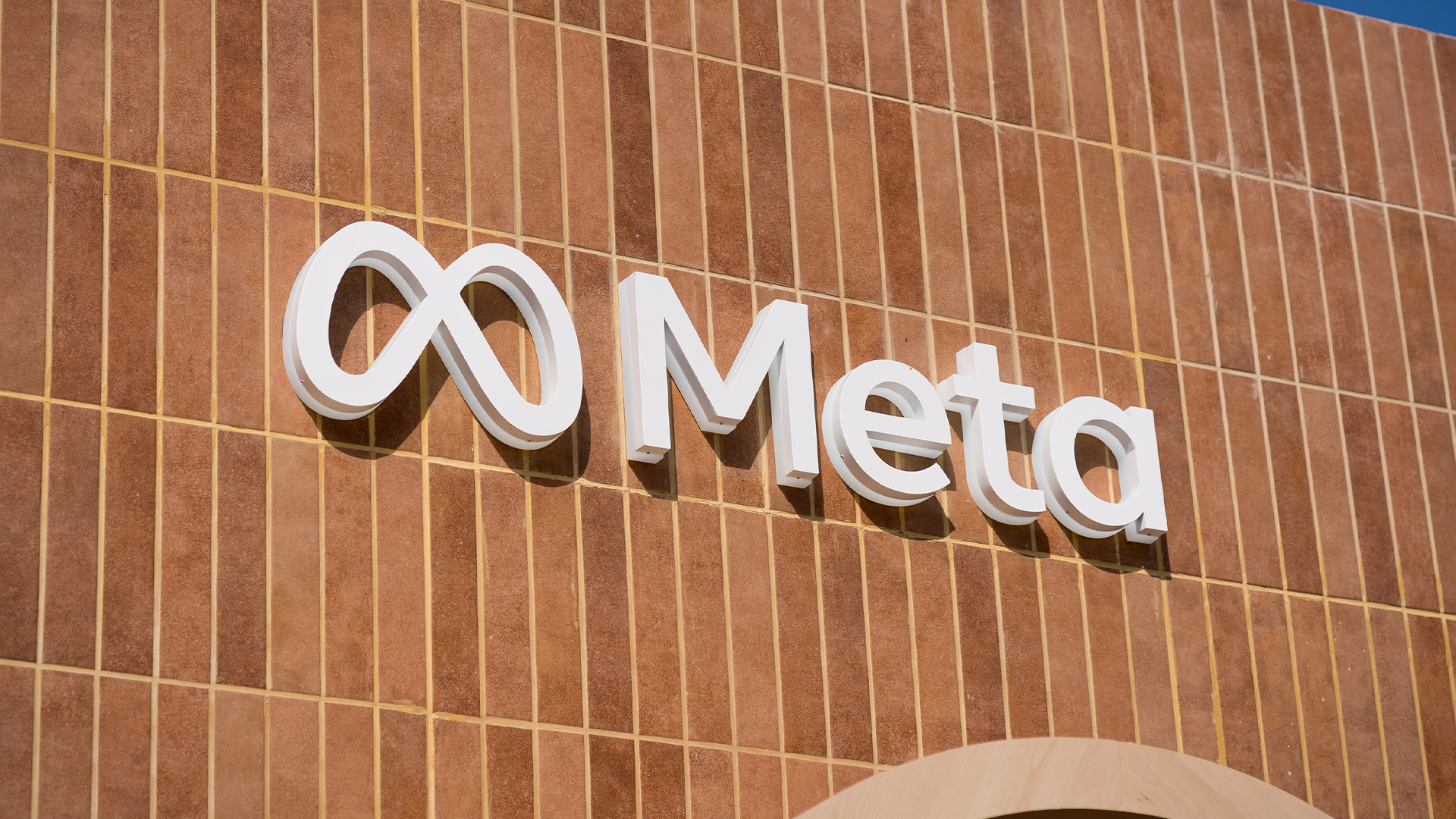 Meta logo and branding pictured in white coloring against a brick wall backdrop at Mobile World Congress 2026 (MWC) at the Fira de Barcelona.