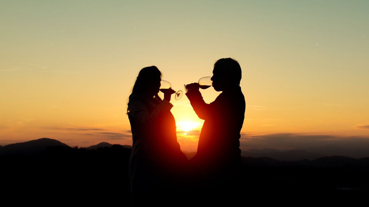 People drinking wine at sunset