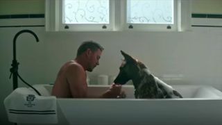 A scene from Channing Tatum's dog film showing him in the bath with pup