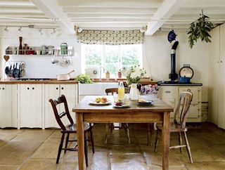 Kitchen in a timber frame cottage with white exposed beams