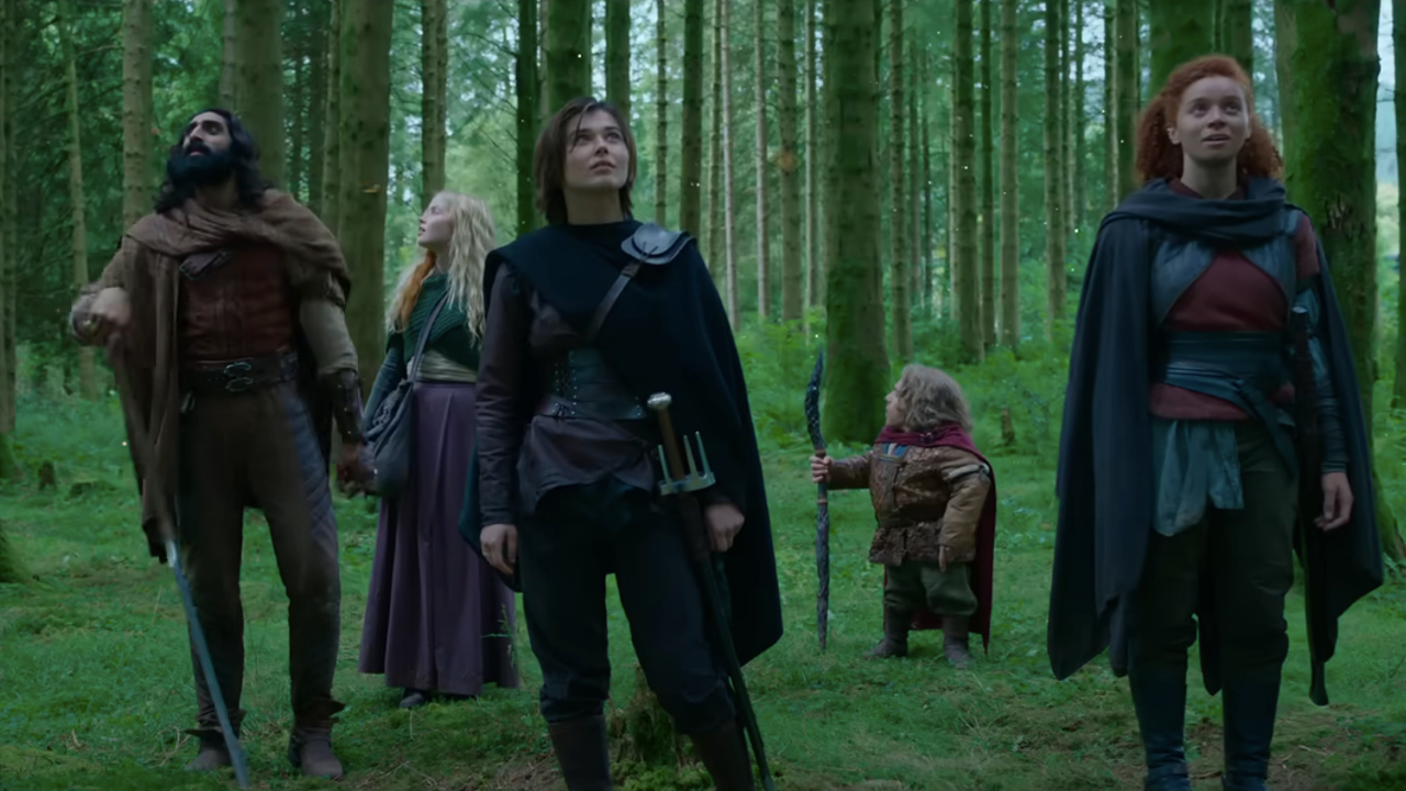 Amar Chadha-Patel, Ellie Bamber, Ruby Cruz, Warwick Davis, and Erin Kellyman look around the forest in wonder in Willow.