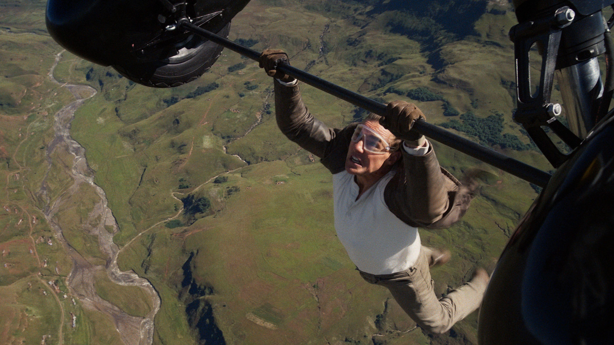Tom Cruise hanging from a plane in Mission Impossible: The Final Reckoning.