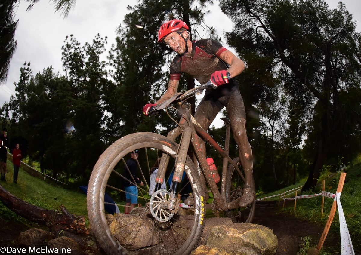 Russell Finsterwald (SRAM/TLD/Scott) riding a rock garden with two laps remaining