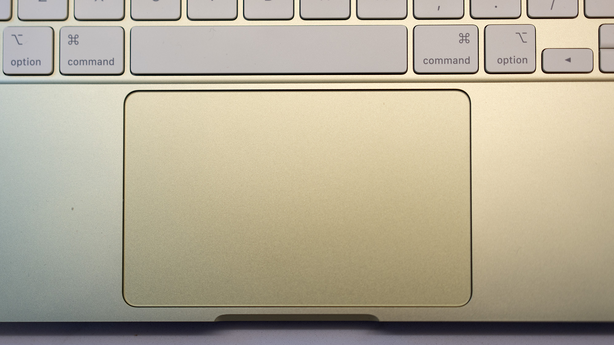 Apple MacBook Neo laptop in yellow on a desk