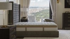 Saatva Loom & Leaf on a bed against a window looking out onto Central Park.