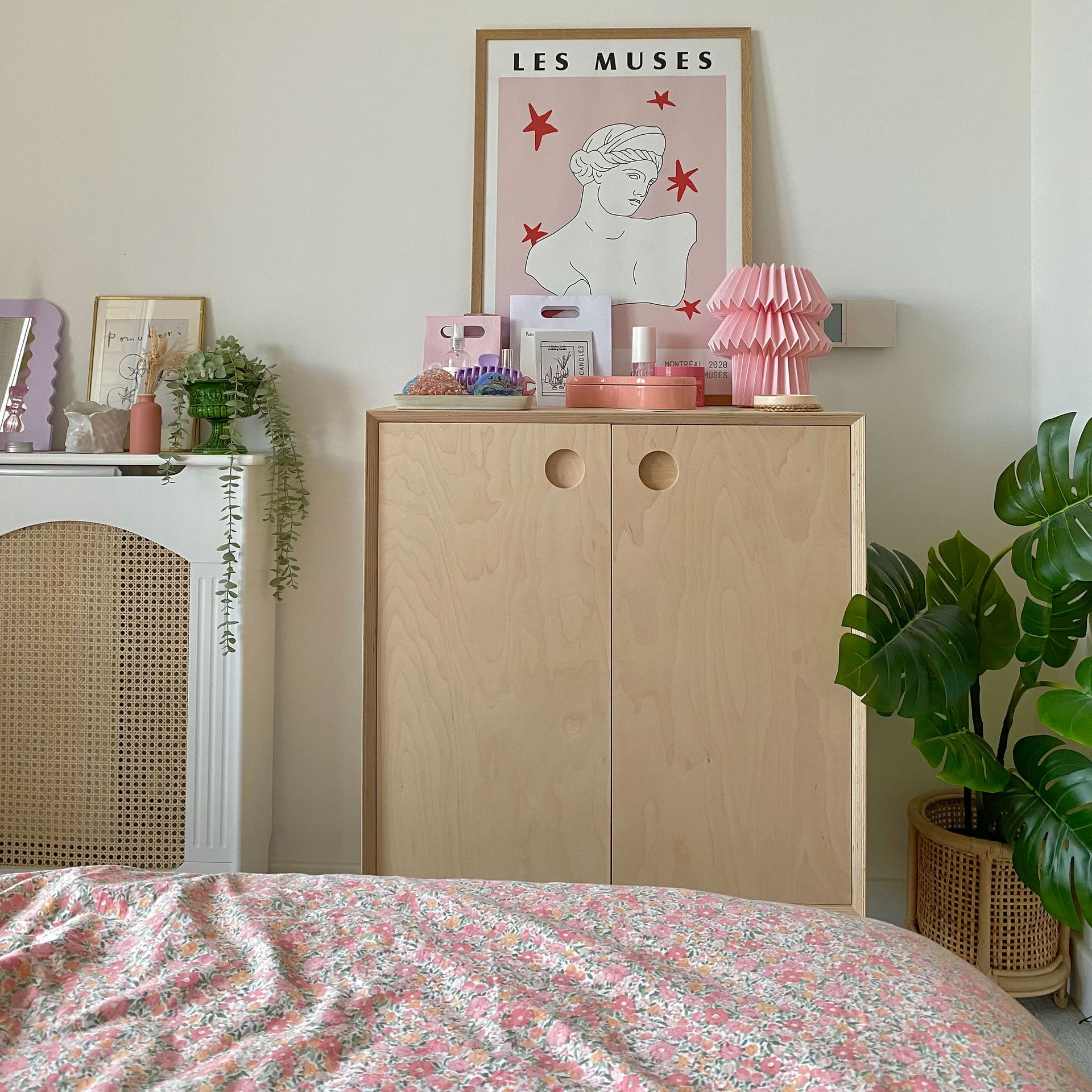 Konsol skandi kayu dengan dekorasi aksen kap lampu merah muda dan cetakan gambar garis merah muda miring