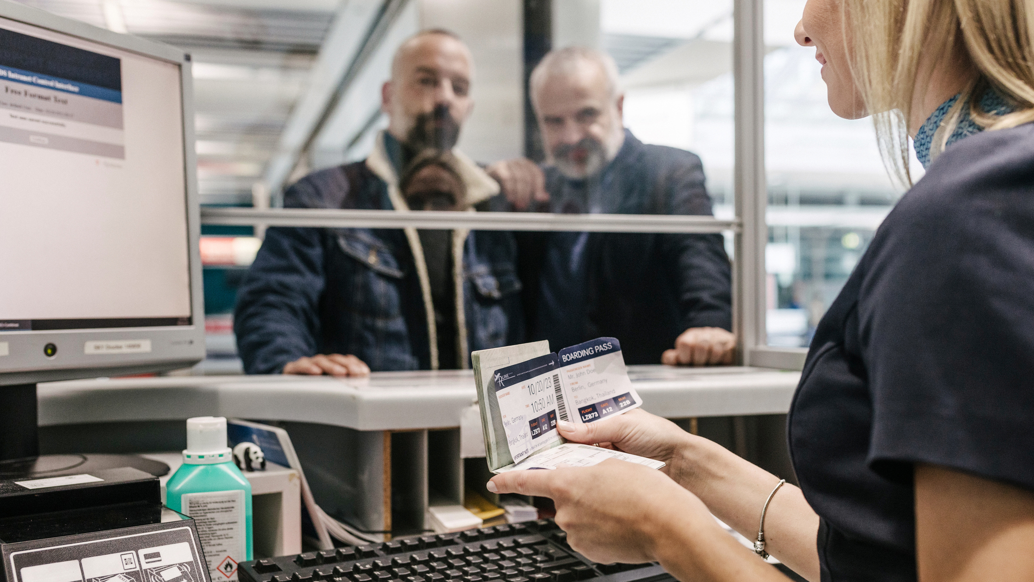 Border agent checking boarding pass
