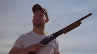 Dwayne (Jake Weary) with shotgun in hand in How To Blow Up a Pipeline