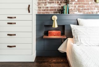 A bedroom with storage built into the wainscoting