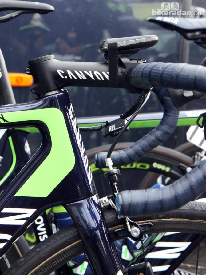 Canyon frames are known for having relatively long head tubes. This Movistar rider opts for a -17&deg; stem to get a lower bar height. Note the strip of tape securing the O.Synce computer, too