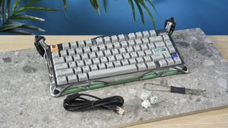 A gray GravaStar Mercury K1 Pro mechanical keyboard, with spider legs