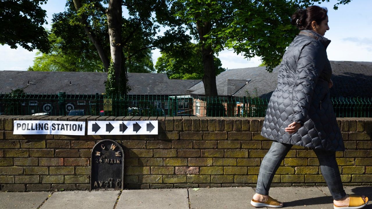 A woman walks to the polling station