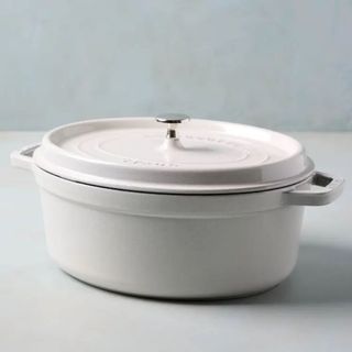A white Magnolia oval cooking pot on a white backgrouund